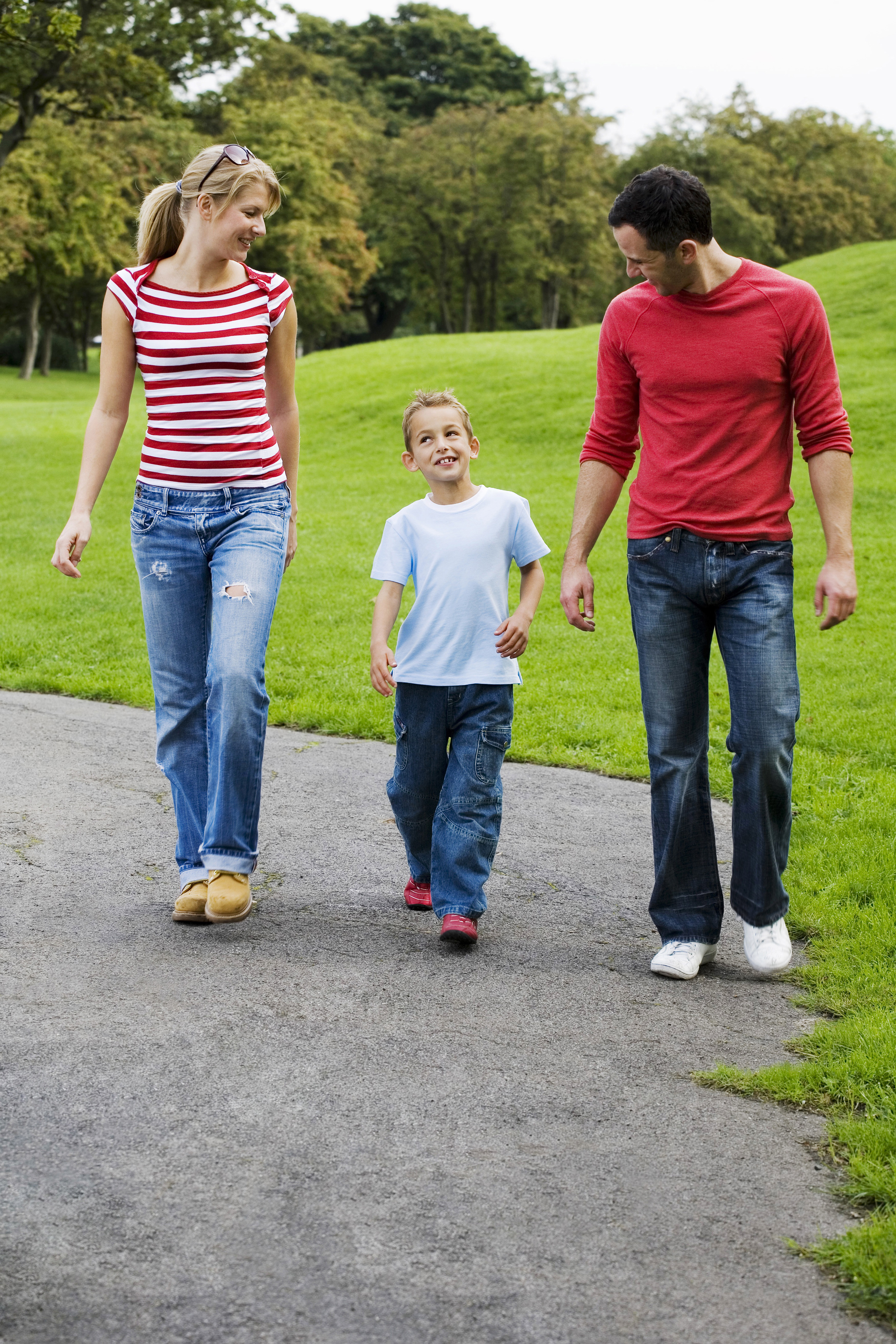 parents and son walking in the park